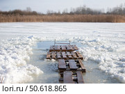 There is an ice hole for walruses to swim in the icy water. Winter baptismal font for the Orthodox feast of the Epiphany. Стоковое фото, фотограф Лазаренко Светлана / Фотобанк Лори