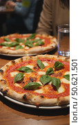 Authentic gourmet pizza selection served on restaurant table for sharing between friends during night out. Fresh ingredients and crispy crust on Italian traditional cuisine. Стоковое AI-видео, аниматор Sergey Grishin / Фотобанк Лори