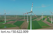 Wind turbines and agriculture fields. Стоковое видео, видеограф Михаил Коханчиков / Фотобанк Лори