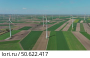 Wind turbines and agriculture fields. Стоковое видео, видеограф Михаил Коханчиков / Фотобанк Лори