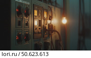 Control panel displaying switches and indicators in a dimly lit room during early morning hours. Стоковое AI-изображение, AI-художник Сергей Толмачёв / Фотобанк Лори