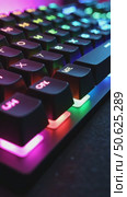 Close up of professional gaming keyboard with colorful LED backlight in multiple colors. Technology in gaming or developer industry. Desktop computer accessories. Стоковое AI-видео, аниматор Sergey Grishin / Фотобанк Лори