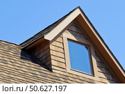 House Exterior. Roof Window. Second floor among blue sky. Mansard attic. Newly build houses. Gable roof with skylight, asphalt roofing, shingles. Residential Home. Vinyl Siding. Polymeric roof-tiles. Стоковое AI-изображение, AI-художник Марина Демидюк / Фотобанк Лори