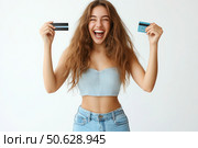 A woman is holding a credit card and smiling. Стоковое AI-изображение, AI-художник Ярославский Максим / Фотобанк Лори