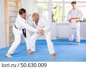 Two experienced male karatekas practicing techniques in friendly kumite. Стоковое фото, фотограф Яков Филимонов / Фотобанк Лори