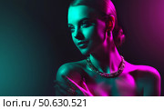 Fashion model woman in colorful bright lights with trendy makeup . Beautiful girl with set jewelry . Woman in a necklace with a ring, earrings and a bracelet. Beauty and accessories. Стоковое фото, фотограф Sofia Zhuravetc / Фотобанк Лори