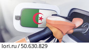 The flag of Algeria on the hatch of the gas tank of a car at a gas station. Gasoline and diesel fuel in Algeria. High prices for diesel fuel, gasoline and gas at gas stations in Algeria. Problems with refueling a car in Alger. Стоковое фото, фотограф Владимир Разгуляев / Фотобанк Лори