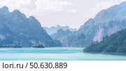 The serene landscape includes Misty Mountains and Calm waters that create a picturesque landscape. Panorama of Cheo Lan Lake in Thailand. Стоковое фото, фотограф Владимир Разгуляев / Фотобанк Лори