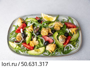 Warm salad with rapans (snails), tomatoes, avocado, arugula, black olives, onions and olive oil. Traditional seafood salad. Close-up, selective focus. Стоковое фото, фотограф Наталья Любина / Фотобанк Лори