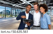 Three people are standing in a large room, with one of them holding a tablet. Стоковое AI-изображение, AI-художник Ярославский Максим / Фотобанк Лори