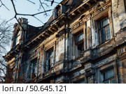 Crumbling facade of abandoned building reflecting neglect and decay. Стоковое AI-изображение, AI-художник Иван Рябоконь / Фотобанк Лори