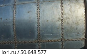 Old metal silver surface of the aircraft fuselage with rivets. Стоковое AI-видео, аниматор Sergey Grishin / Фотобанк Лори