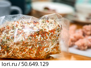 Mix of dried fruits for soups in a plastic bag on a table, containing pieces of dried onion, carrot, pepper and other vegetables. Стоковое фото, фотограф Татьяна Степанищева / Фотобанк Лори