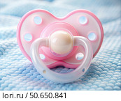 Close-Up of Pink Baby Pacifier on Blue Fabric. Generative AI. Стоковое AI-изображение, AI-художник Roman Zavorotny / Фотобанк Лори