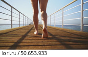 A woman goes swimming on a bridge in the sea. Стоковое видео, видеограф Igor Skripachev / Фотобанк Лори