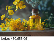 Yellow flowers essence extracted in a small glass bottle with cork. Стоковое AI-изображение, AI-художник Иван Рябоконь / Фотобанк Лори