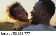 Happy black african father holding embracing cute little child daughter. Стоковое AI-видео, аниматор Sergey Grishin / Фотобанк Лори