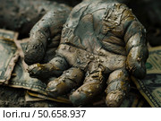 Muddy hand grasping dollar bills symbolizing corruption and greed. Стоковое AI-изображение, AI-художник Иван Рябоконь / Фотобанк Лори
