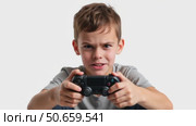 Young boy playing video game with focused expression indoors. Стоковое AI-видео, аниматор KATERINA AI / Фотобанк Лори