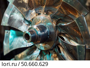 Damaged turbine rotor with traces of magnetic particle inspection undergoing maintenance. Стоковое AI-изображение, AI-художник Иван Рябоконь / Фотобанк Лори