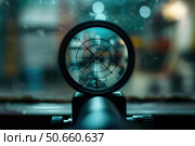 Optical sight showing crosshair reticle with rain drops on lens. Стоковое AI-изображение, AI-художник Иван Рябоконь / Фотобанк Лори