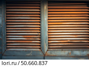Rusty ventilation grilles creating a textured industrial background. Стоковое AI-изображение, AI-художник Иван Рябоконь / Фотобанк Лори