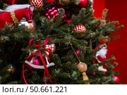 Close-up. Beautiful red horse on a Christmas tree. Beautiful Christmas background. Concept of preparing for the New Year. New Year's card 2026. Стоковое фото, фотограф Photojuli / Фотобанк Лори