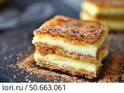 Bougatsa, greek custard pie layered with crispy phyllo dough and sprinkled with powdered sugar. Стоковое AI-изображение, AI-художник Иван Рябоконь / Фотобанк Лори