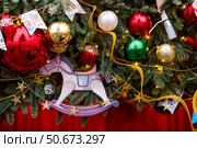 Close-up. Beautiful red horse on a Christmas tree. Beautiful Christmas background. Concept of preparing for the New Year. New Year's card 2026. Стоковое фото, фотограф Photojuli / Фотобанк Лори