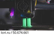 Modern 3d printer creating a green plastic object using innovative technology in a laboratory setting, showcasing the advancements in additive manufacturing. Стоковое видео, видеограф Ольга Ильина / Фотобанк Лори