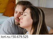 Mature couple hugging hugging each other kissing at home bedroom. Intimate Moment. Tender embrace shared between a loving middle age man and woman, husband and wife. Deep love. Low key, cinematic. Стоковое фото, фотограф Марина Демидюк / Фотобанк Лори