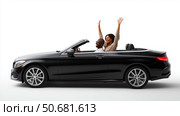 Happy couple enjoying a sunny ride in a convertible car with arms raised in celebration. Стоковое AI-изображение, AI-художник Сергей Толмачёв / Фотобанк Лори
