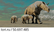 A Paraceratherium mother with two twin calves walks along a desert. Стоковое фото, фотограф Corey Ford/Stocktrek Images / ТАСС / Фотобанк Лори