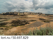 View of the fortress city of Saint-Malo on the English Channel and the ocean floor exposed at low tide on a sunny summer day, Brittany, France. Стоковое фото, фотограф Ula Ulachka / Фотобанк Лори