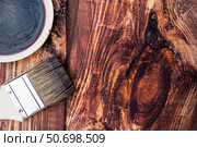The procedure for protecting and coating wooden boards. The texture of wood treated with stain. Close-up of stain and brush. Стоковое фото, фотограф Photojuli / Фотобанк Лори