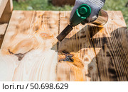 The process of burning wooden boards with a burner. The texture of wood treated with fire from a burner. Close-up. Стоковое фото, фотограф Photojuli / Фотобанк Лори