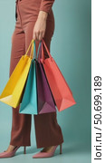 A Stylish Woman With Colorful Shopping Bags Smiles at the Camera Against a Teal Background, Embodying Retail and Fashion Joy. Стоковое AI-видео, аниматор Sergey Grishin / Фотобанк Лори