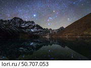 Celestial sky with Sirius, Orion and Aldebaran shining bove Pharilapche Peak in Nepal. Стоковое фото, фотограф Jeff Dai/Stocktrek Images / ТАСС / Фотобанк Лори