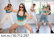 Group of young girls in dark glasses and ball cap and guy dance jazz-funk in fitness club. Стоковое фото, фотограф Яков Филимонов / Фотобанк Лори