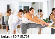 Young woman doing choreography at ballet barre. Стоковое фото, фотограф Яков Филимонов / Фотобанк Лори