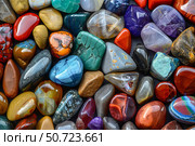 Colorful tumbled gemstones creating a vibrant background showing variety of colors and textures. Стоковое AI-изображение, AI-художник Иван Рябоконь / Фотобанк Лори