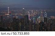 Wonderful aerial view of skyscrapers in downtown and Victoria Harbor in Hong Kong at night. Awesome cityscape. Hong Kong is a popular tourist destination of Asia. Редакционное видео, видеограф Ирина Михайличенко / Фотобанк Лори