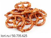 Small crunchy pretzels piled up on white background. Стоковое AI-изображение, AI-художник Иван Рябоконь / Фотобанк Лори