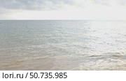 A tranquil scene of the sea meeting the horizon under a sky filled with clouds. Calmness and beauty of nature concept. High quality footage. Стоковое видео, видеограф Ирина Михайличенко / Фотобанк Лори
