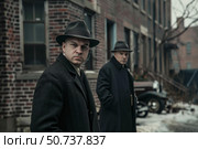 Serious gangsters wearing hats standing on street in winter. Стоковое AI-изображение, AI-художник Иван Рябоконь / Фотобанк Лори