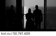 Bride and groom going out onto the balcony with a view of the sea. Стоковое видео, видеограф Tatiana Malinsky / Фотобанк Лори