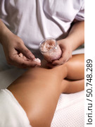 Thigh Massage With Scrub for Relaxation and Rejuvenation Indoors at a Wellness Retreat. Стоковое фото, фотограф Aleksandr Golubev / Фотобанк Лори