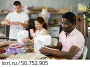 Students work with sewing machines under guidance of teacher. Стоковое фото, фотограф Яков Филимонов / Фотобанк Лори