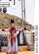 ELANTSY, IRKUTSK REGION, RUSSIA - July 5, 2025: Erdynskie Games – festival of nomadic peoples of Eurasia. Beautiful Buryat girl in national costume and fur hat on open stage in Beauty Contest. Редакционное фото, фотограф Виктория Катьянова / Фотобанк Лори