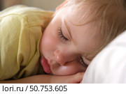Peaceful adorable baby sleeping on a bed at home. Slumbering little child. Two years old girl sleeps peaceful at domestic room interior background. Serene dream. Cute face close up. Deep kid slumber. Стоковое фото, фотограф Марина Демидюк / Фотобанк Лори